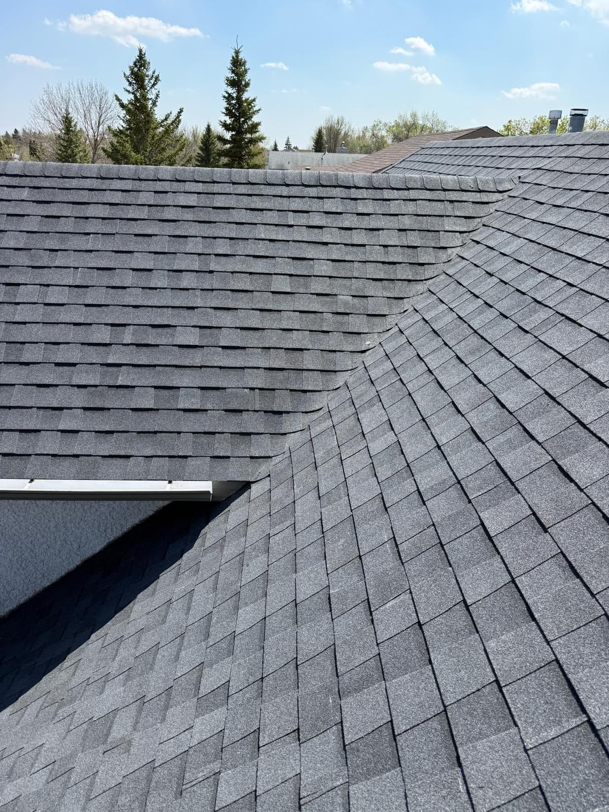 Crisp new asphalt shingles on a completed Winnipeg roof