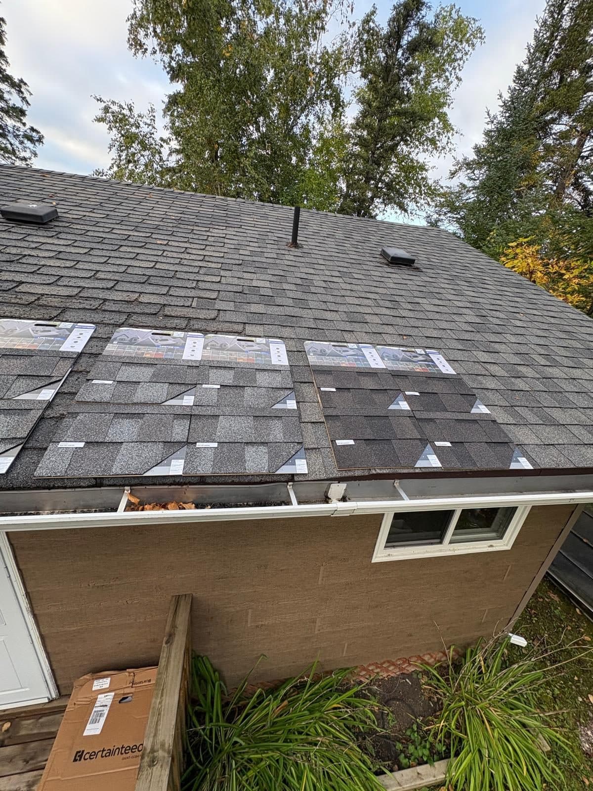 New grey shingle roof on a brick bungalow